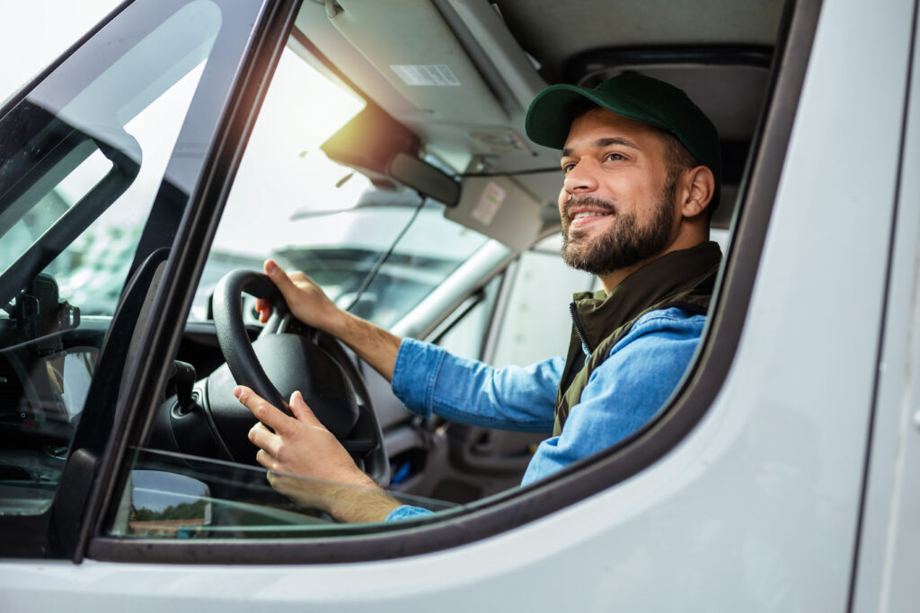 Young handsome man working in towing service and driving his truck.